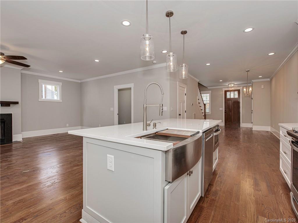 1808 Berryhill Road Charlotte, NC 28208 - Photo 9 of 34 a large kitchen with stainless steel appliances granite countertop a lot of counter space and wooden floor