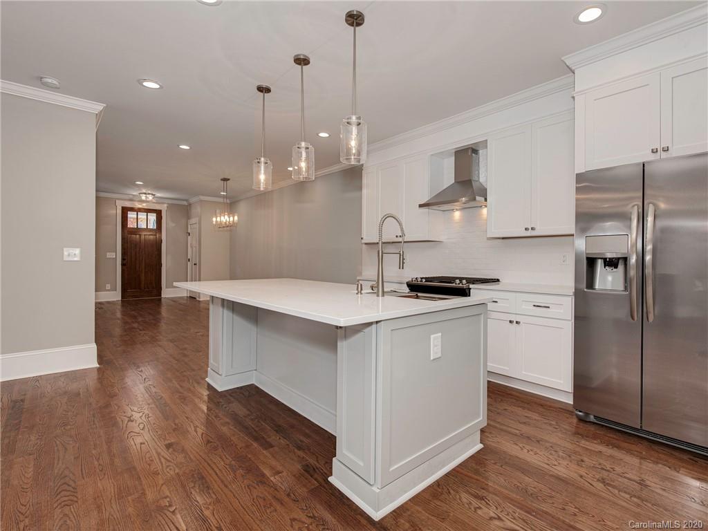 1808 Berryhill Road Charlotte, NC 28208 - Photo 10 of 34 a kitchen with stainless steel appliances granite countertop a sink a stove a refrigerator and island with wooden floor