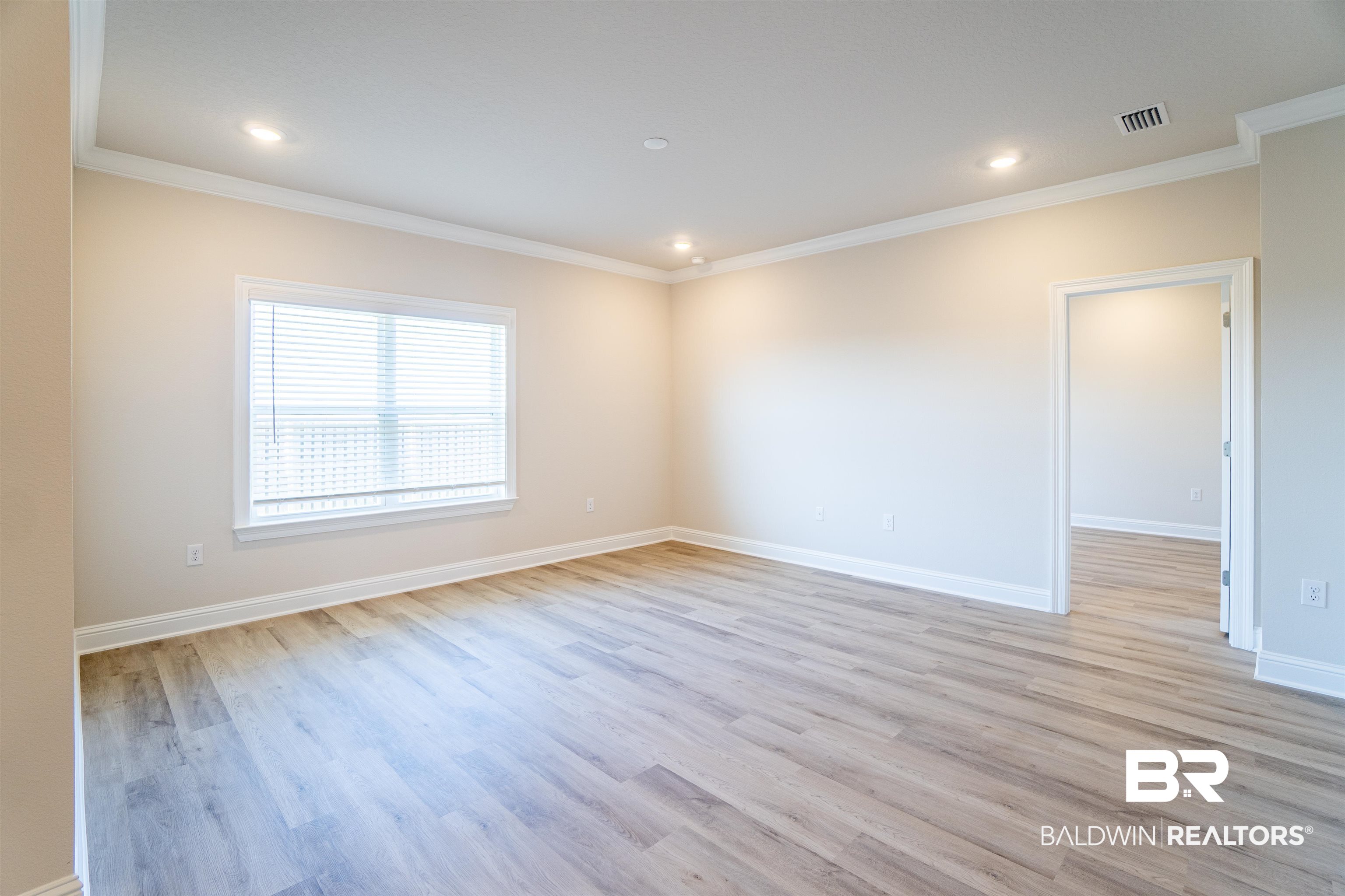 1073 Hayward Loop Foley, AL 36535 - Photo 16 of 18 Spacious room featuring wood-finish flooring, recessed lighting, crown molding, and a window with blinds