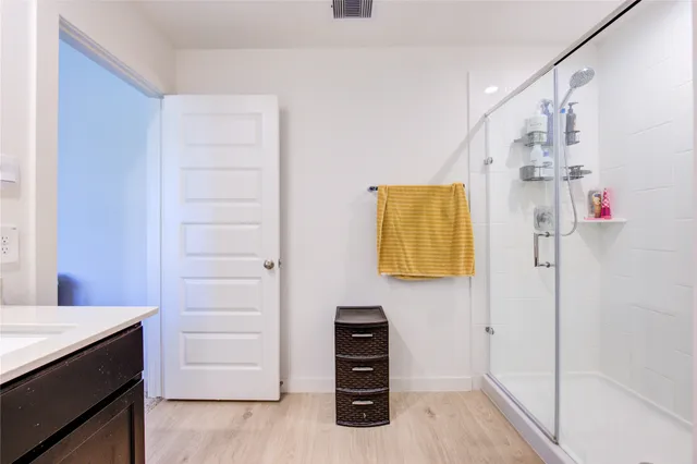 a spacious bedroom with a bed and a flat screen tv