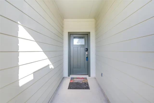 an empty room with windows and ceiling fan view