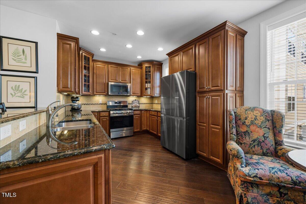 10520 Sablewood Drive, Unit 103 Raleigh, NC 27617 - Photo 11 of 38 a kitchen with stainless steel appliances granite countertop a refrigerator stove and oven