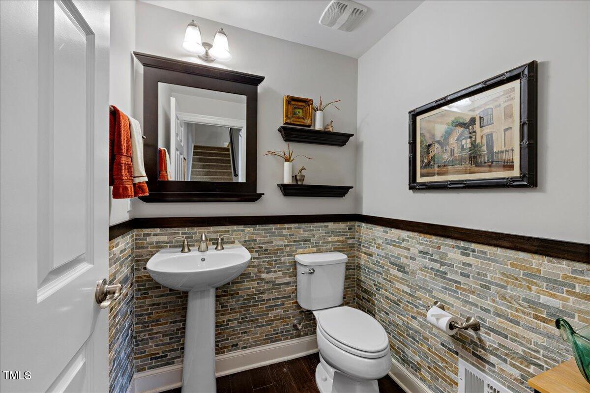 10520 Sablewood Drive, Unit 103 Raleigh, NC 27617 - Photo 14 of 38 a bathroom with a toilet sink and mirror