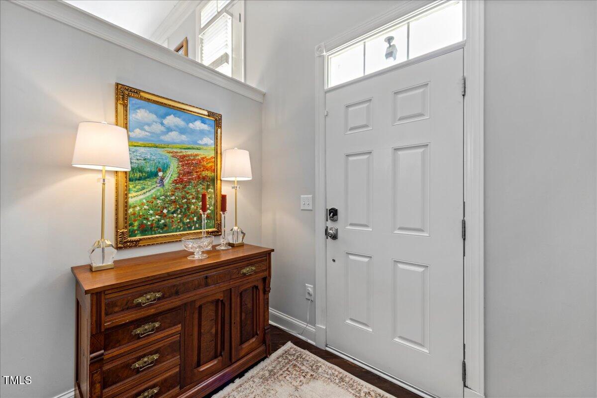 10520 Sablewood Drive, Unit 103 Raleigh, NC 27617 - Photo 15 of 38 a view of a dresser with mirror in front of door
