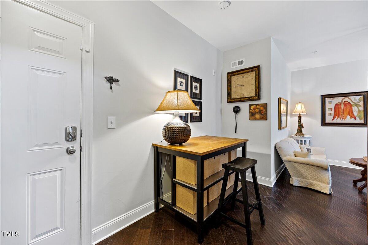 10520 Sablewood Drive, Unit 103 Raleigh, NC 27617 - Photo 16 of 38 a bedroom with a bed and wooden floor