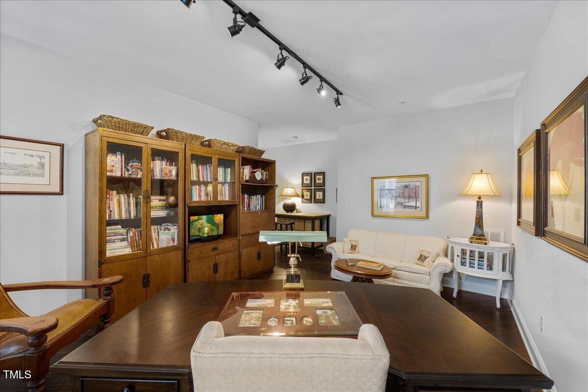 10520 Sablewood Drive, Unit 103 Raleigh, NC 27617 - Photo 18 of 38 a living room with lots of furniture and wooden floor