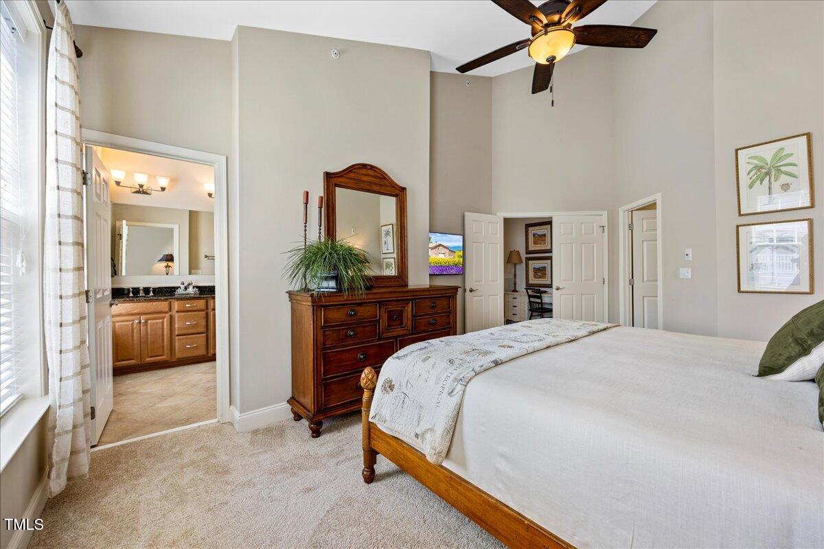 10520 Sablewood Drive, Unit 103 Raleigh, NC 27617 - Photo 27 of 38 a spacious bedroom with a bed and a dresser