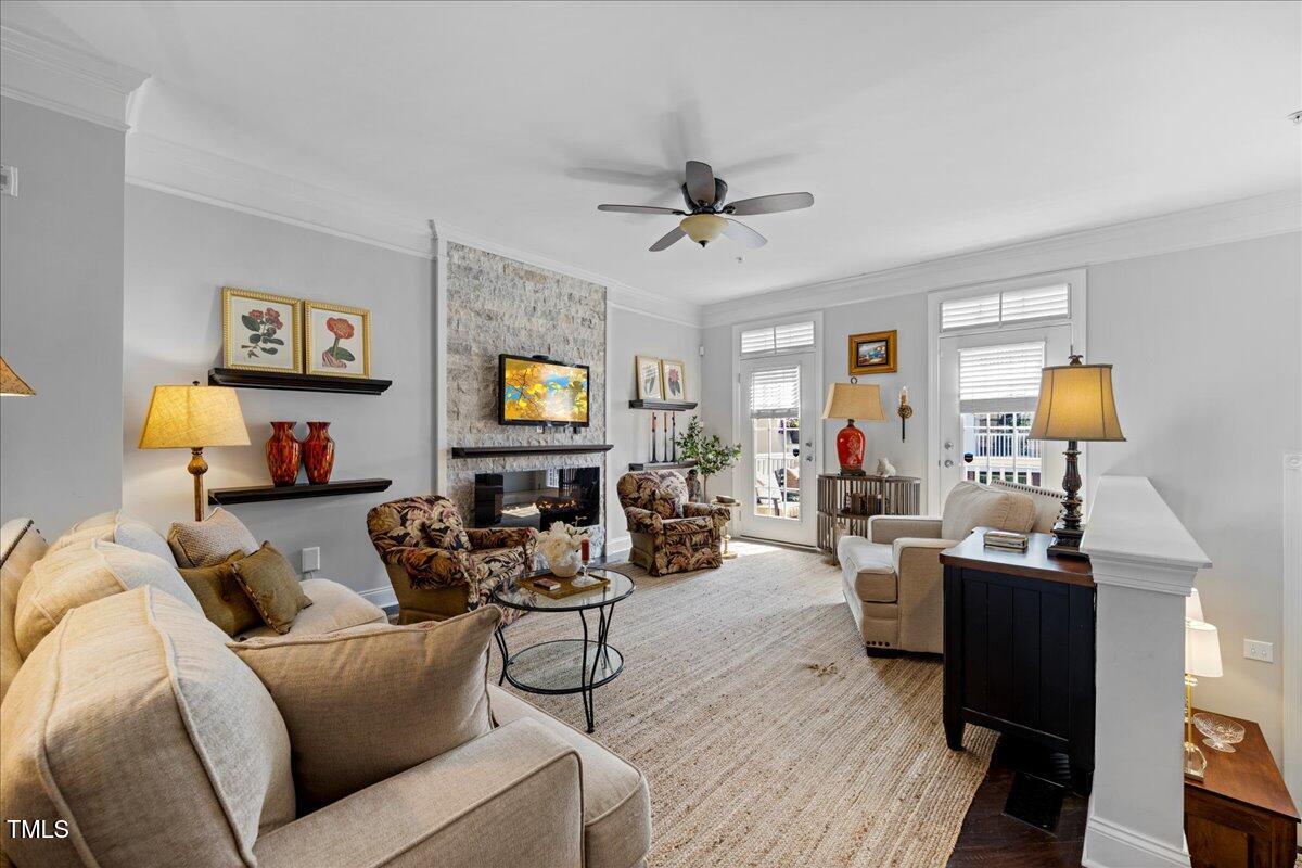 10520 Sablewood Drive, Unit 103 Raleigh, NC 27617 - Photo 2 of 38 a living room with furniture and a flat screen tv