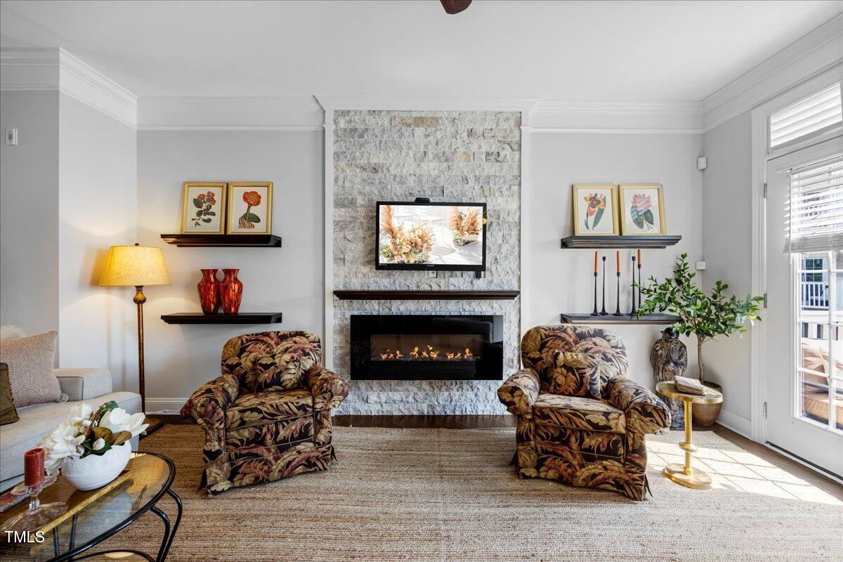 10520 Sablewood Drive, Unit 103 Raleigh, NC 27617 - Photo 3 of 38 a living room with furniture and a fireplace