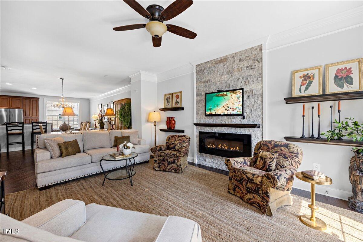 10520 Sablewood Drive, Unit 103 Raleigh, NC 27617 - Photo 4 of 38 a living room with furniture and a fireplace