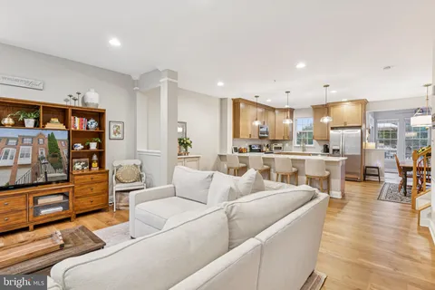 a living room with furniture and a kitchen view