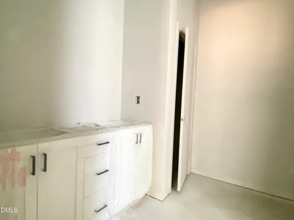 a view of a kitchen with white cabinets