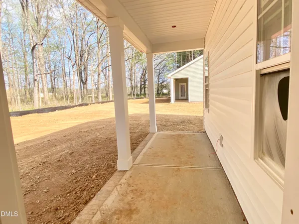 a view of a porch with wooden floor and fence