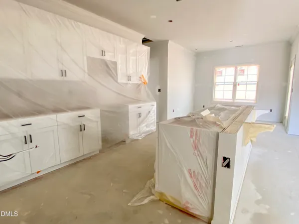 a utility room with cabinets washer and dryer