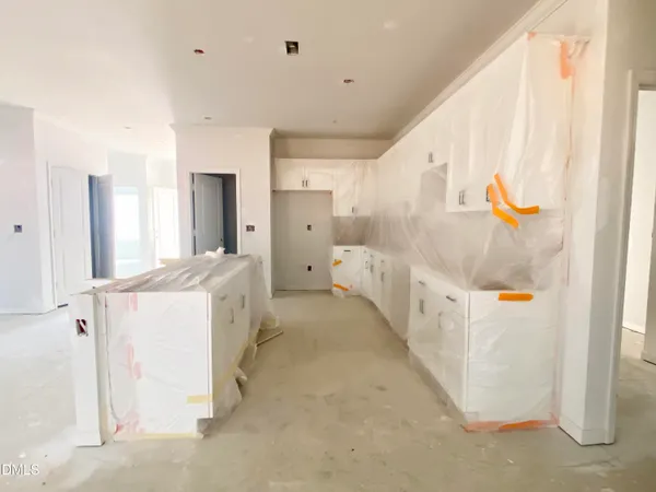 a large white kitchen with a sink
