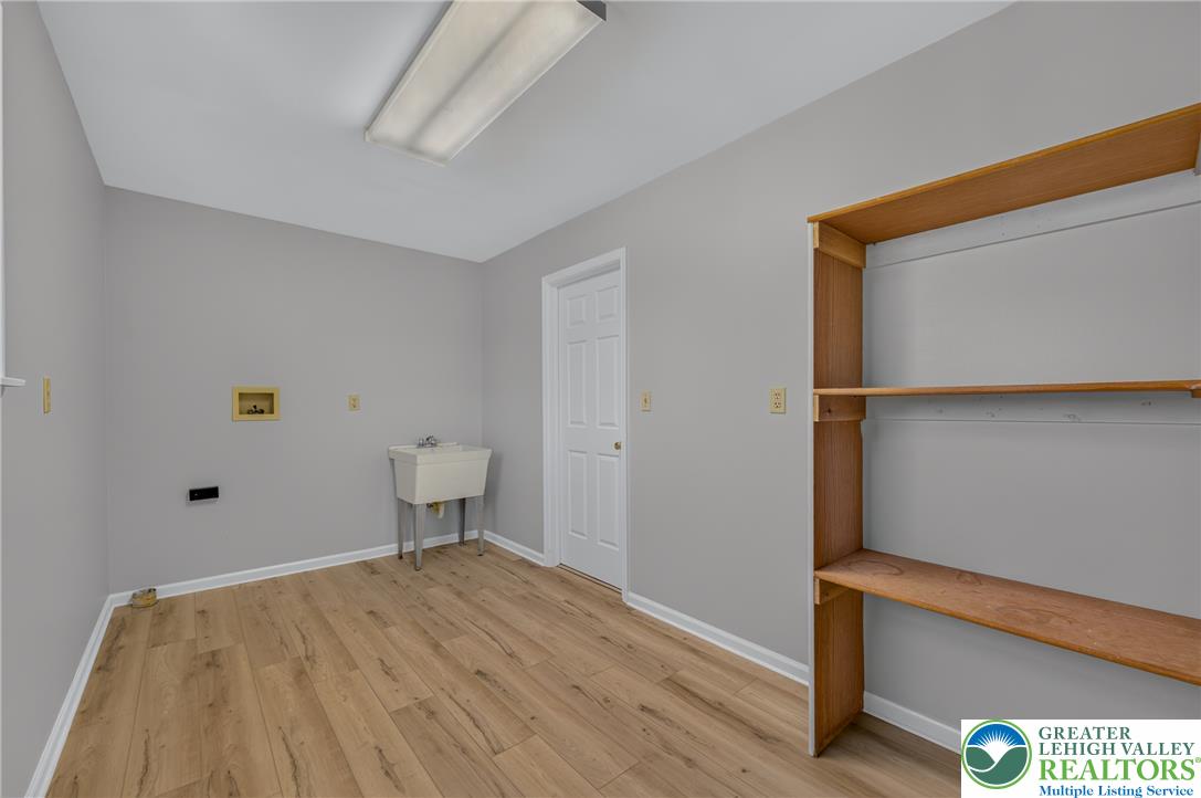 630 Clearfield Road Nazareth, PA 18064 - Photo 68 of 100 Functional utility space features wood-style flooring and integrated storage shelving.