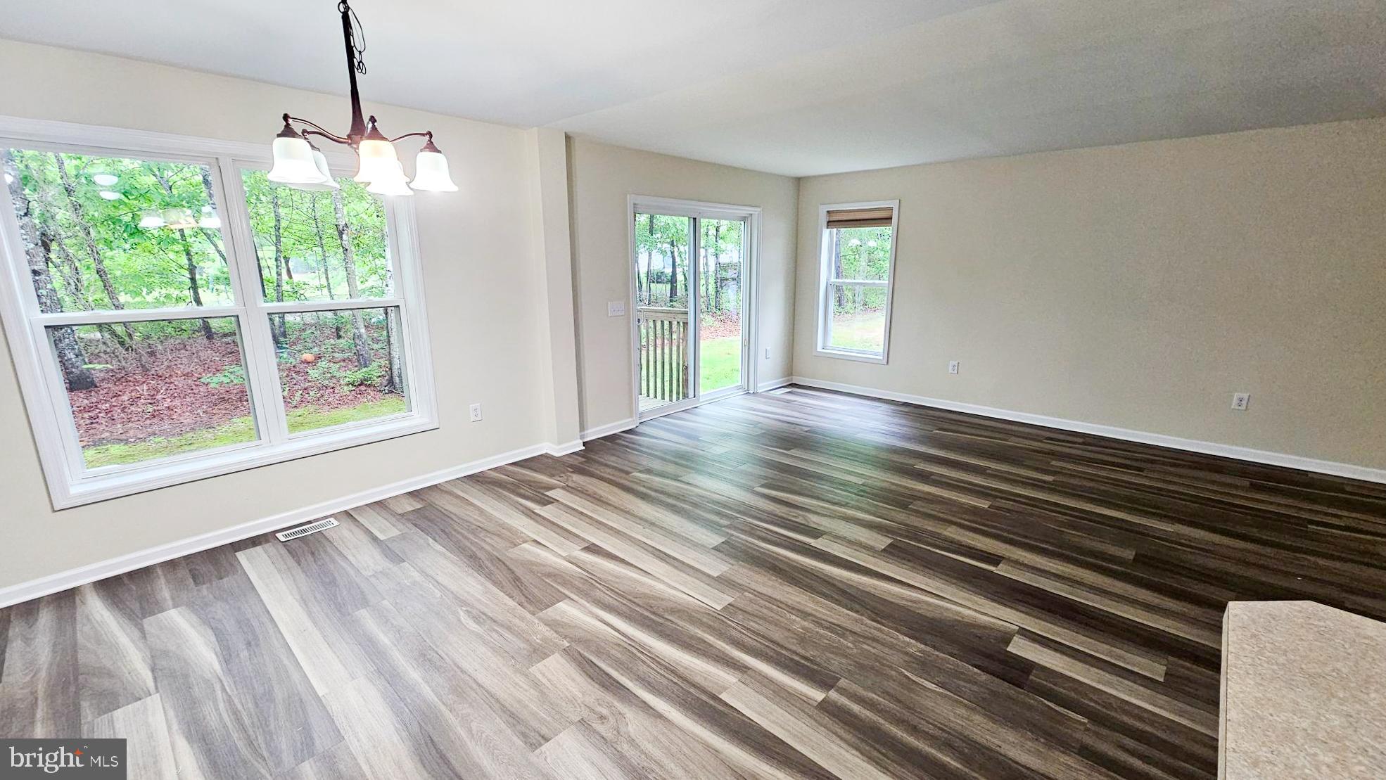 380 Radio Road, Unit B 6 Little Egg Harbor, NJ 08087 - Photo 11 of 33 a view of an empty room with wooden floor and a window