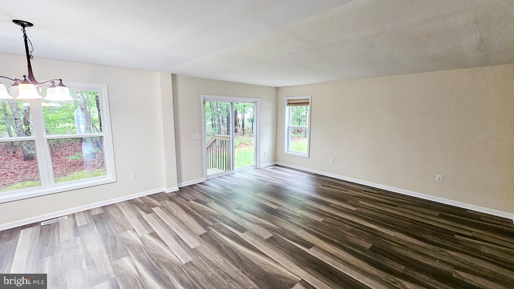 380 Radio Road, Unit B 6 Little Egg Harbor, NJ 08087 - Photo 12 of 33 a view of an empty room with wooden floor and a window