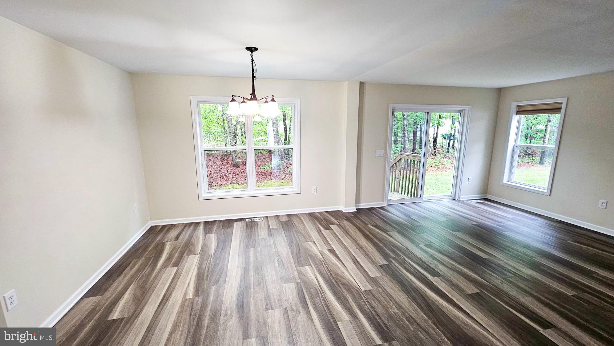 380 Radio Road, Unit B 6 Little Egg Harbor, NJ 08087 - Photo 13 of 33 a view of an empty room with wooden floor fridge and a window