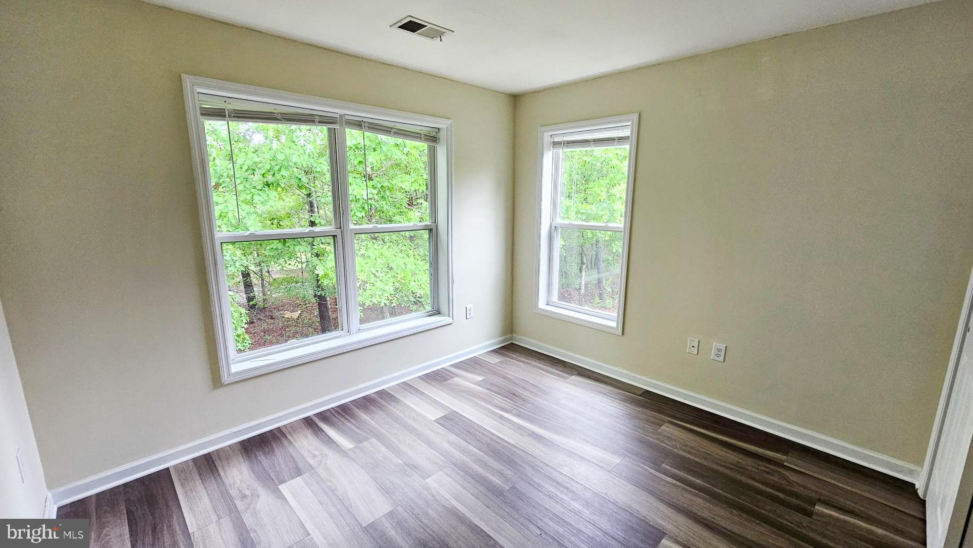 380 Radio Road, Unit B 6 Little Egg Harbor, NJ 08087 - Photo 23 of 33 a view of an empty room with wooden floor and a window