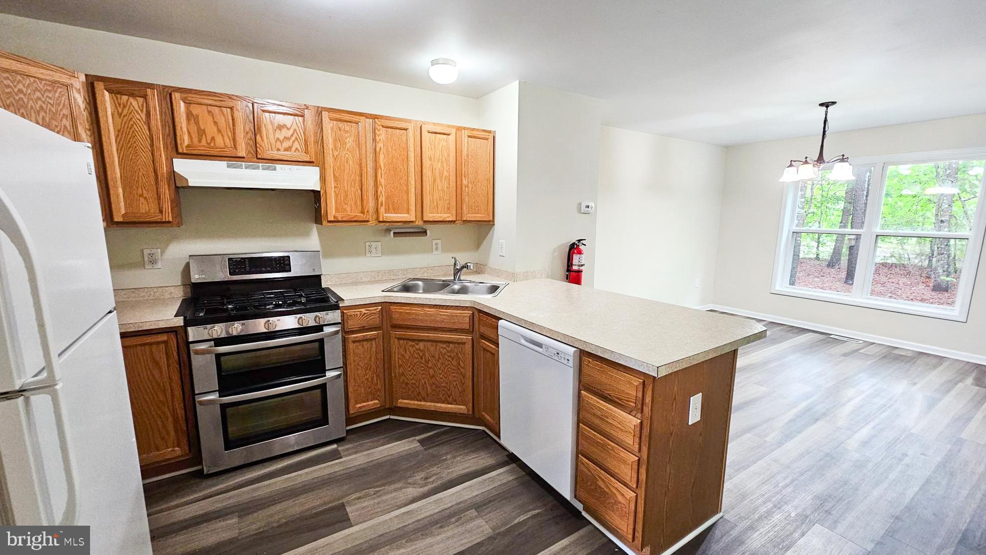 380 Radio Road, Unit B 6 Little Egg Harbor, NJ 08087 - Photo 3 of 33 a kitchen with a stove cabinets and a wooden floor