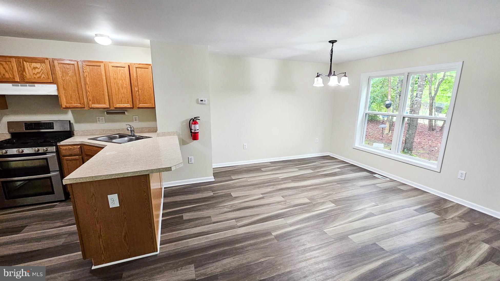 380 Radio Road, Unit B 6 Little Egg Harbor, NJ 08087 - Photo 6 of 33 a kitchen view of a refrigerator stove a sink and dishwasher with wooden floor