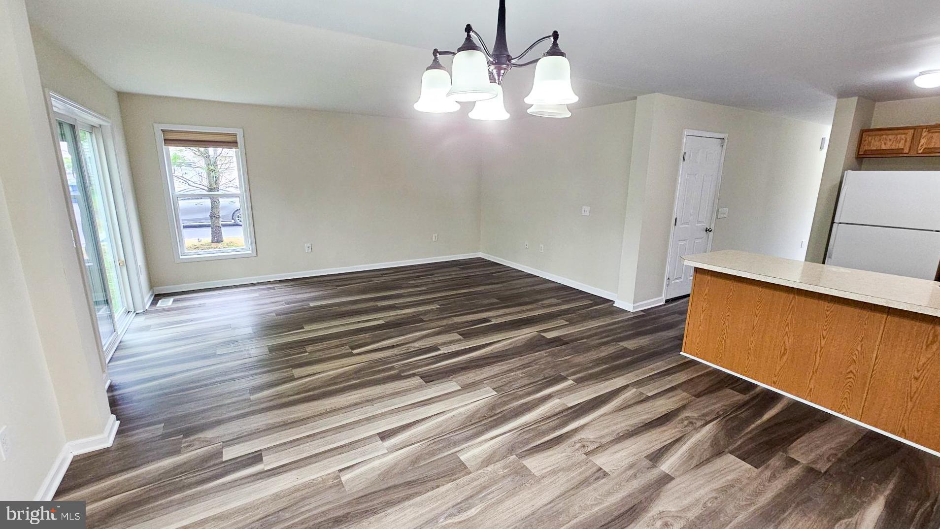 380 Radio Road, Unit B 6 Little Egg Harbor, NJ 08087 - Photo 10 of 33 a view of an empty room with wooden floor and a window