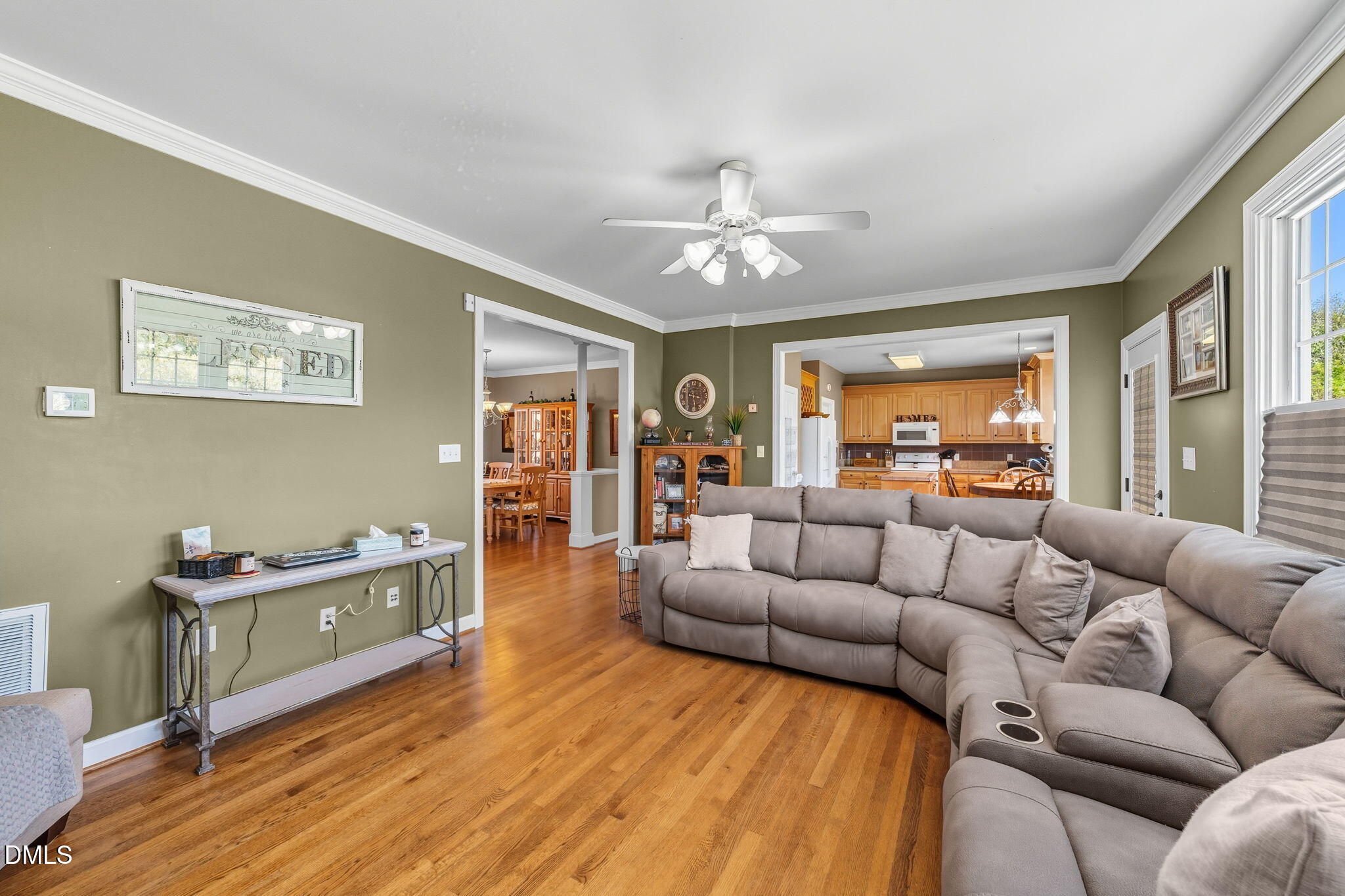 1617 Kendall Hill Road Willow Spring, NC 27592 - Photo 29 of 58 a living room with furniture and a wooden floor