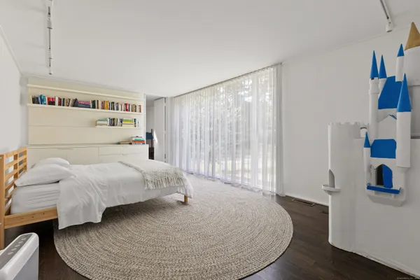 a bedroom with a bed and a window
