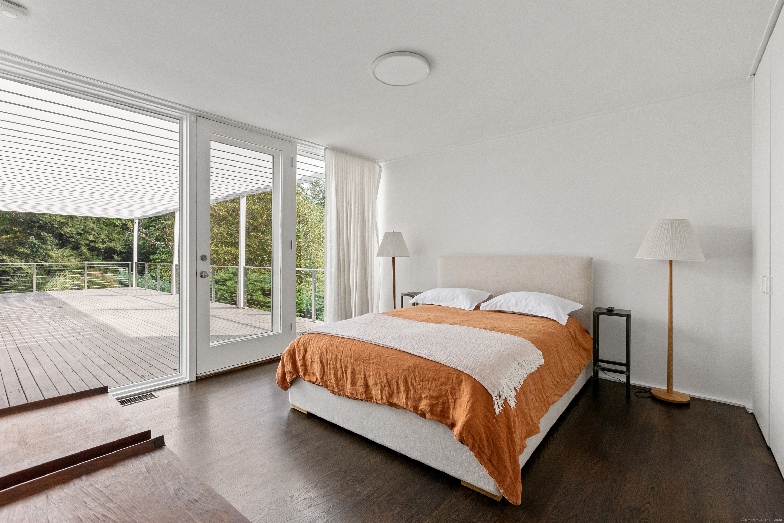 26 Chalburn Road Redding, CT 06896 - Photo 27 of 27 a bedroom with a bed lamp and a large window