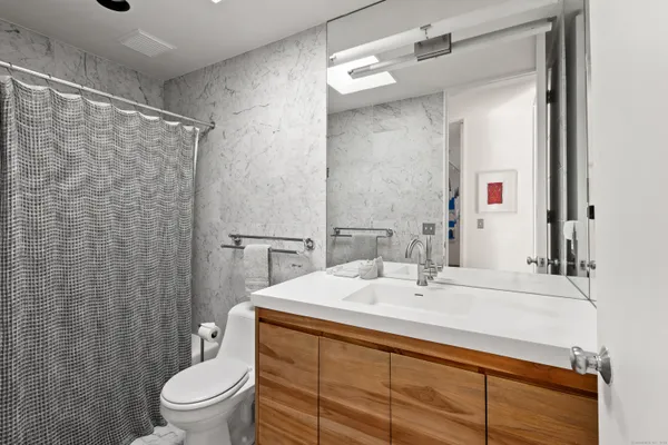 a bathroom with a sink toilet and shower