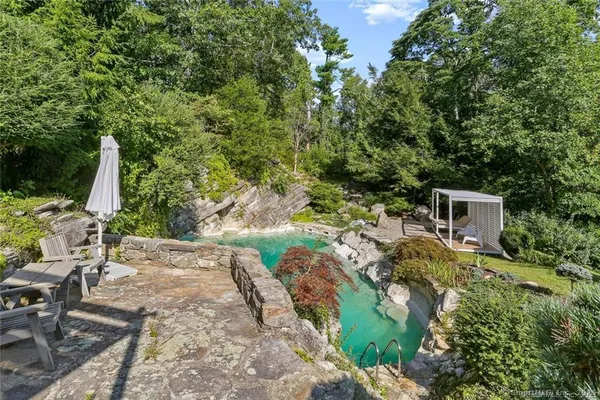 a view of backyard with outdoor seating and green space