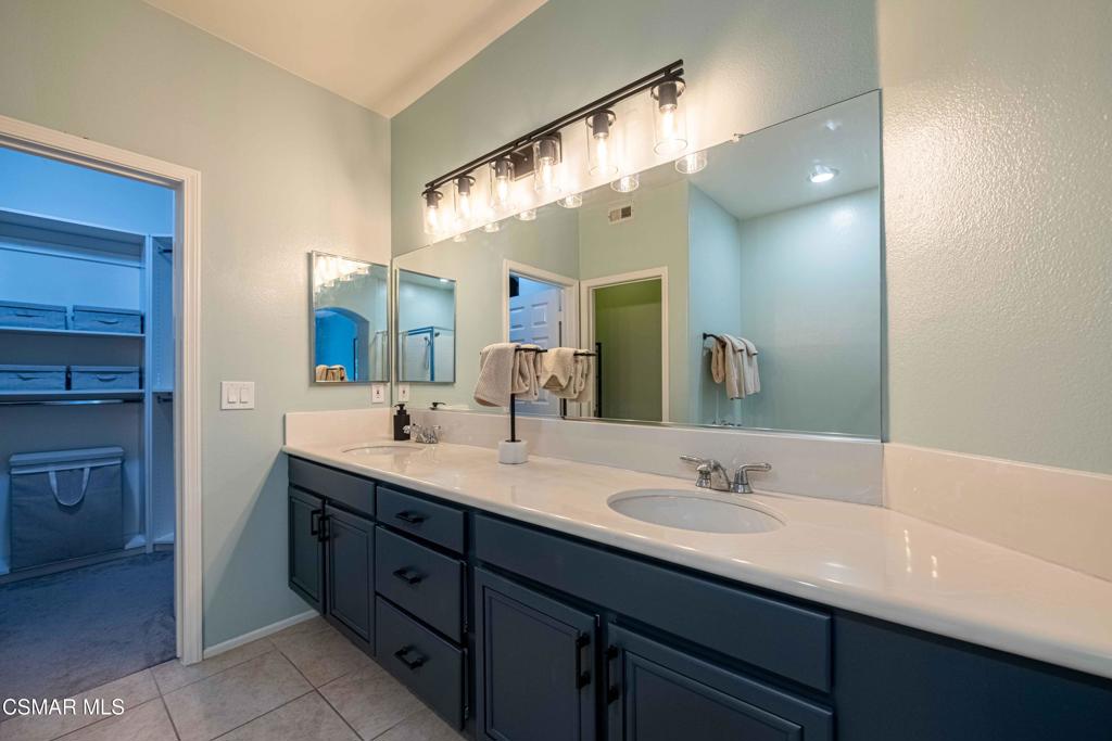 580 Fenwick Way, Unit C Simi Valley, CA 93065 - Photo 24 of 39 a bathroom with a double vanity sink and a mirror