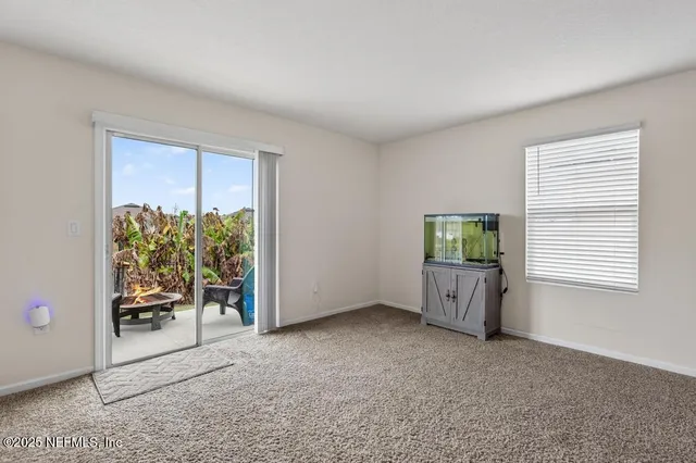 a bedroom with a bed a flat screen tv and a chandelier