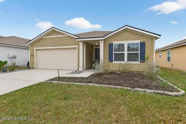a front view of a house with a yard and garage