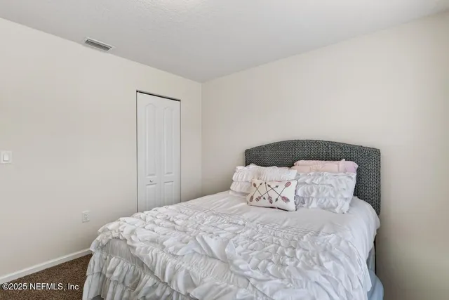 a roof deck with table and chairs and a potted plant