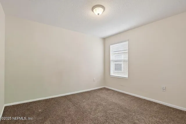 a view of a porch with furniture and a yard