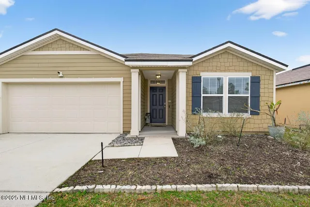 a front view of a house with garden