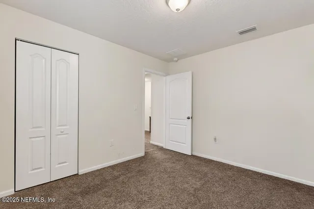 a front view of a residential houses with yard and green space
