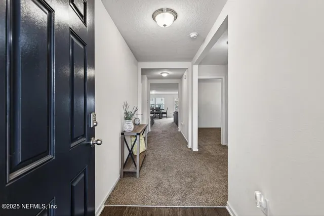a view of entryway with furniture and wooden floor