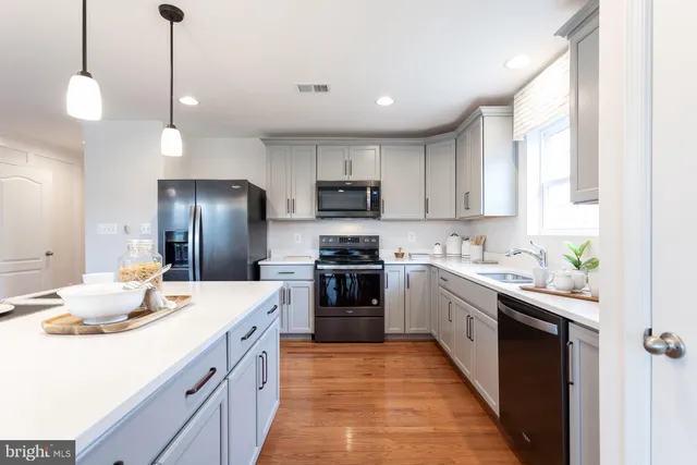a kitchen with a sink stove and refrigerator