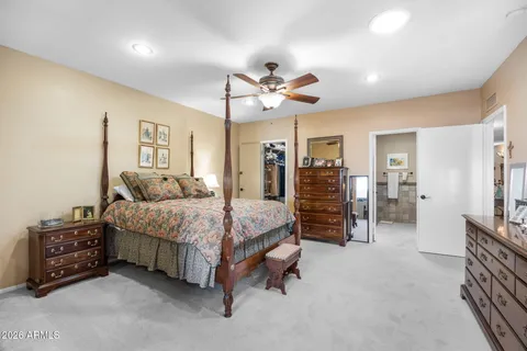 a spacious bedroom with a bed and a walk in closet