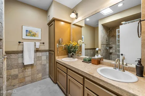 a bathroom with a sink double vanity and a mirror