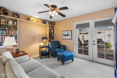 a living room with furniture and a ceiling fan