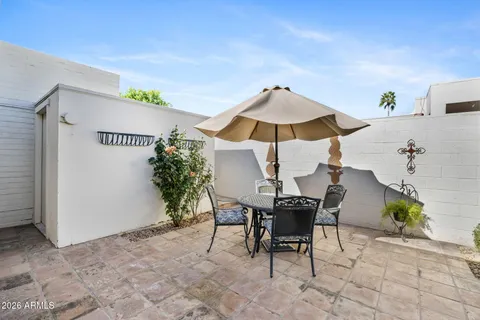 a view of a patio with furniture and a umbrella