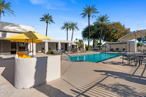 a view of a house with swimming pool and sitting area