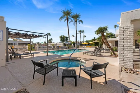 a view of swimming pool with outdoor seating and deck