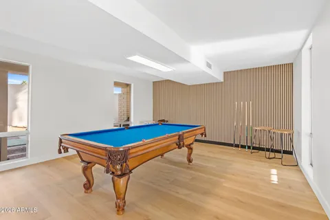 a room with pool table and windows