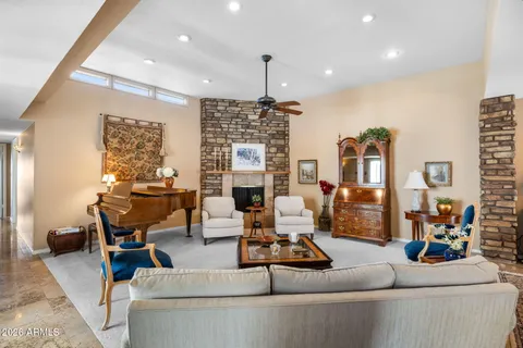 a living room with fireplace furniture and a chandelier