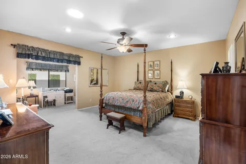 a spacious bedroom with a bed and furniture